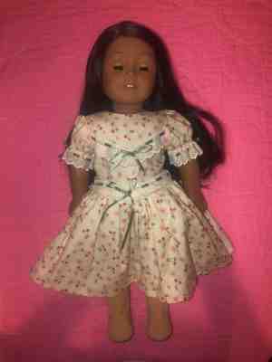 american girl doll, brown skin, long dark brown hair, and blue eyes