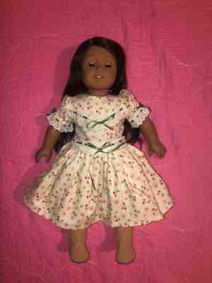 american girl doll, brown skin, long dark brown hair, and blue eyes