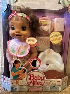 baby alive hasbro 2006  new , brown hair . Comes with toilet , food , pampers .