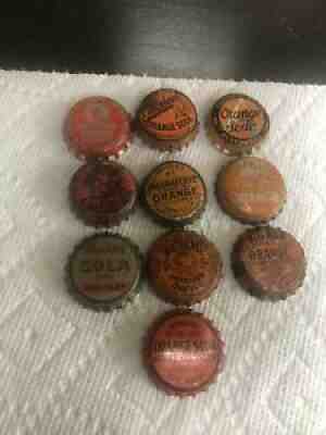 10 orange cork backed soda caps, 2 missing cork