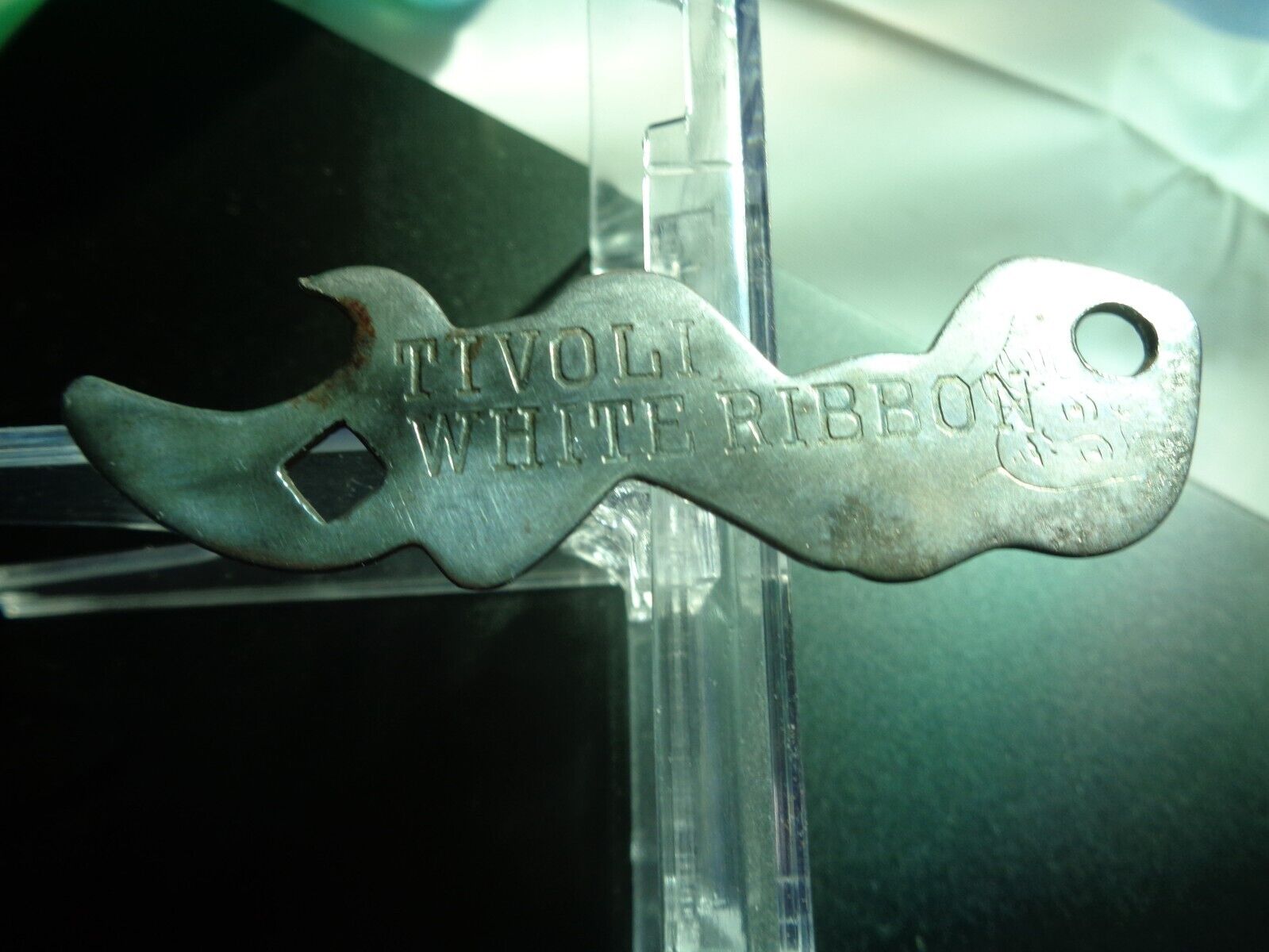 Tivoli white ribbon beer opner in the figore of a lady