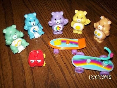 Lot of 5 - 2 1/2"Care Bears with a scooter, skateboard & skates for them to ride