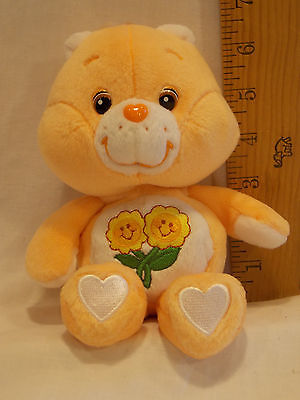 Care Bear collectible - Peach Colored with flower on tummy. Approx. 7 in. sittin