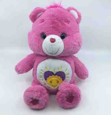 pink care bear with heart and sun