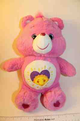 pink care bear with heart and sun