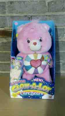 GLOW A LOT CARE BEAR - LOVE - A - LOT BEAR . BRAND NEW IN BOX.