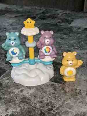 Care Bears Sitting On A Cloud. On a merry-go-round. Three Care Bears