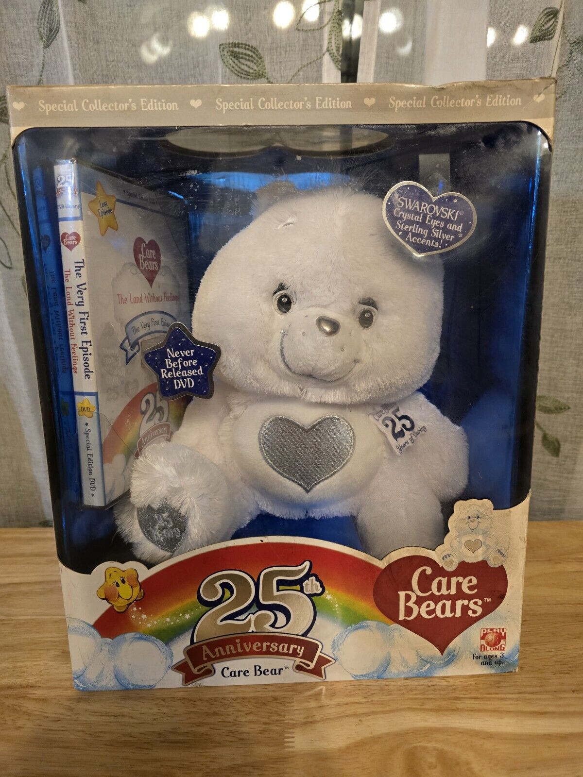 Unopened 25th anniversary care bear with swarovski crystal With dvd