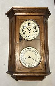 Howard Miller Oak Double Dial Calendar Regulator Westminster Chime Wall Clock