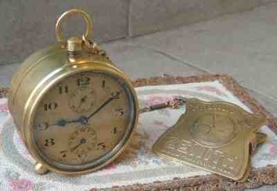 Antique ZENITH Eight Day Table Alarm Clock together with Chain and Money Clip