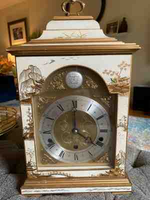 A cream Chinoiserie mantel clock by vintage Elliott of London, England