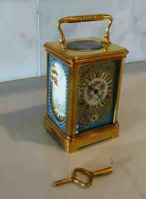 Carriage clock with gilt case and porcelain panels