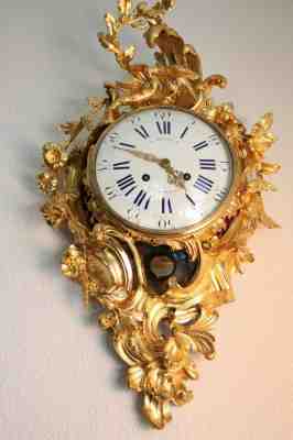 Antique French cartel wall clock of gilt bronze in the Louis XV style