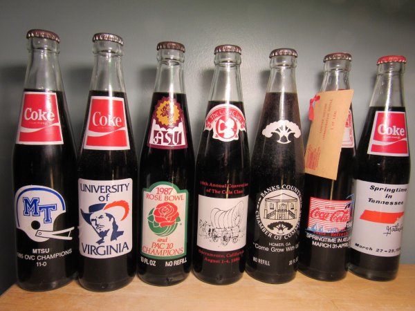 New ListingEclectic Set of 7 - Coca Cola Bottles - All 10 oz. from the 1980's