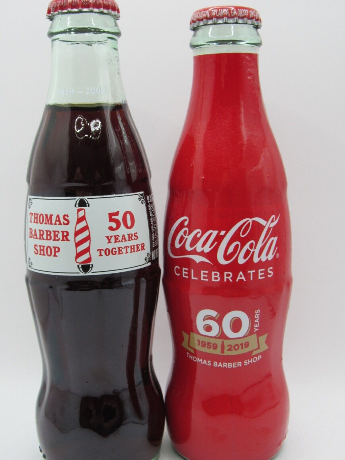 THOMAS' BARBER SHOP - 2 Different Coca Cola Bottles - 50th & 60th  Anniversaries