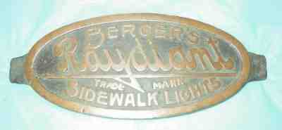 BRASS SIGN: BERGER'S RAYDIANT SIDEWALK LIGHTS; 8" OVAL. 1886-