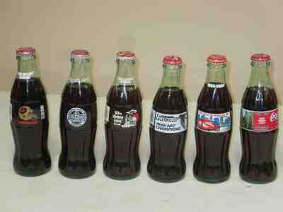 COCA COLA  6 PACK BOTTLES NEVER OPENED ALL DIFFERENT KINDS OF COMMEMORITIVE BOTT
