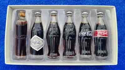 LOT of 2 Sets: Evolution of The COCA-COLA CONTOUR BOTTLE/ of the COCA-COLA SANTA