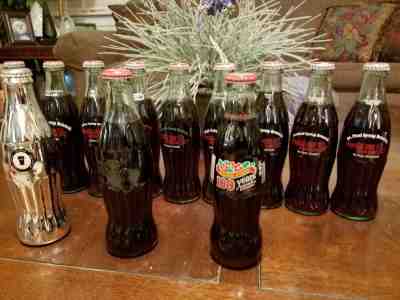 1996/97 9 BOTTLE SET SYRUP BRANCH 8 OZ COCA COLA COMMEMORATIVE BOTTLE 