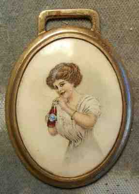 1327 Coca-Cola 1910 Celluloid & Brass Watch Fob Featuring A Gibson Girl