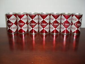 7 Vingage 1960s Coca Cola can's with diamond design.  Empty.
