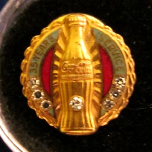Coca Cola service award pin. marked  10K, 35 years, 7 Stones, Diamonds? scarce