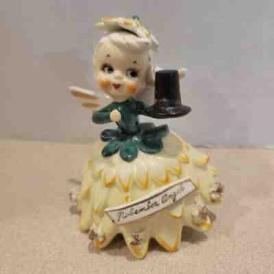 Rare Vintage TMJ Ceramic November Flower Angel Holding Black Pilgrim Hat
