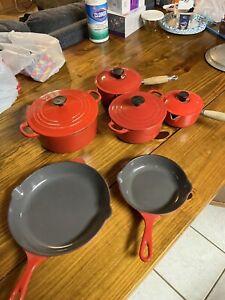 le creuset cast iron red skillet and pots