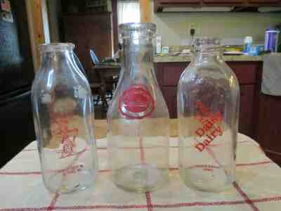 THREE ANTIQUE GLASS MILK BOTTLES ALL FROM DIFFERENT DAIRYS