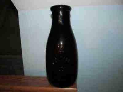 milk bottle Woolman's Buttermilk Keep Cold. 1 qt rd emb Amber Philadelphia Pa.