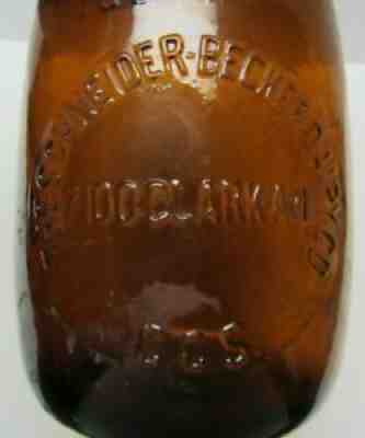 The Schneider Becker Dairy Co. Embossed Quart Amber Milk Bottle Cleveland Ohio.