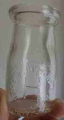 EMBOSSED 1/4 PINT MILK BOTTLE, E. N. HOWARD, CANANDAIGUA, NEW YORK