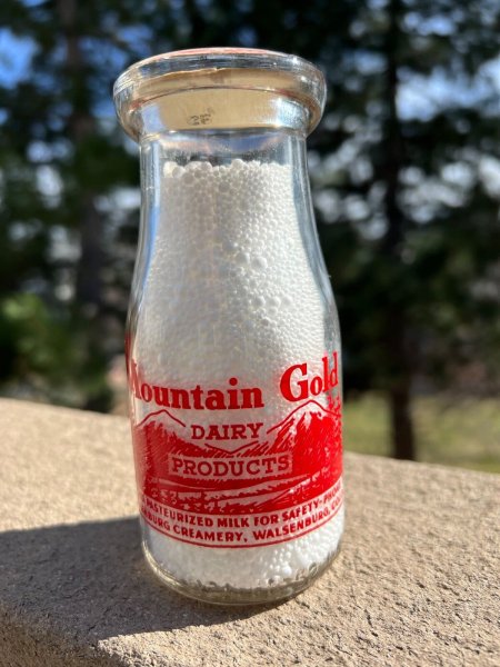 TRP1/2pt Milk Bottle War Slogan MOUNTAIN GOLD DAIRY PRODUCTS WALSENBURG COLORADO