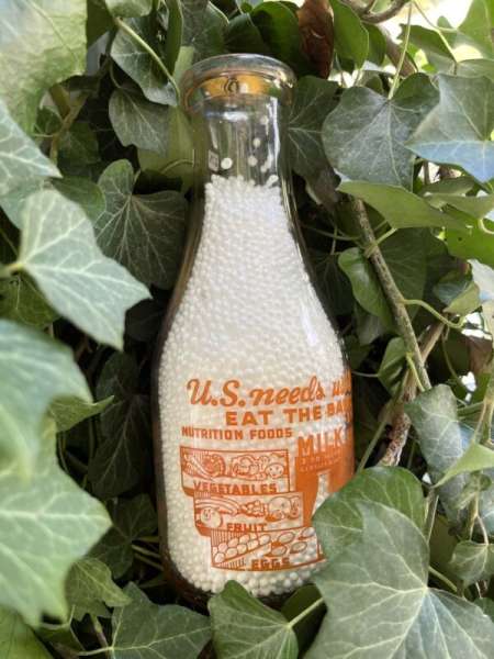 Arnold W. Rowe TRPQ war slogan milk bottle, Rutland VT. U.S. Needs Us Strong gem