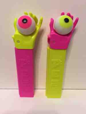 Two PEZ Psychedelic Eye Yellow Neon Pink Stem Hand Mint New Misfit European Euro