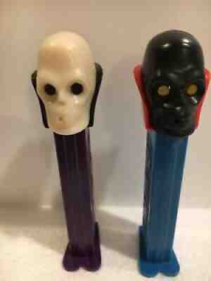 pez Halloween skulls x2 one black head Dr skull one white. pat #4.9 scarce