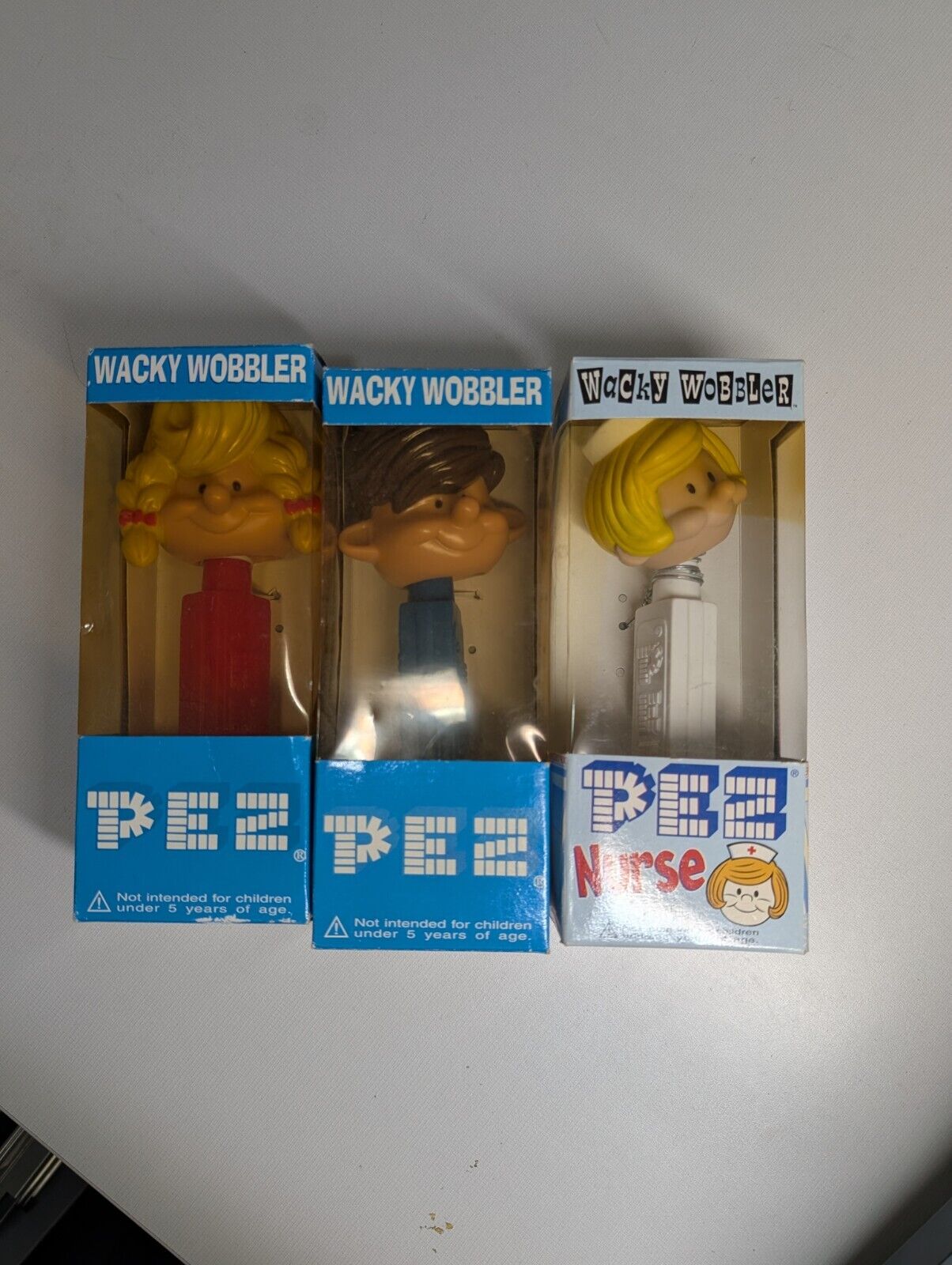 VINTAGE GIRL, BOY, AND NURSE WACKY WOBBLER PEZ COLLECTION LOT NEW, UNOPEN