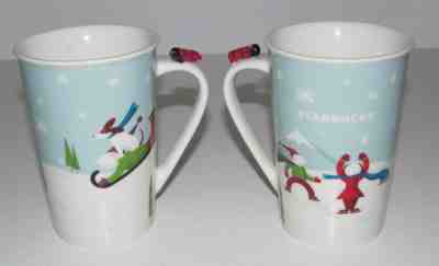 Starbucks Christmas 2011 Holiday Mug Cup Dog Skaters Airplane on Handle Set of 2 - Sold on eBay Nov, 28th 2018 for $15.99